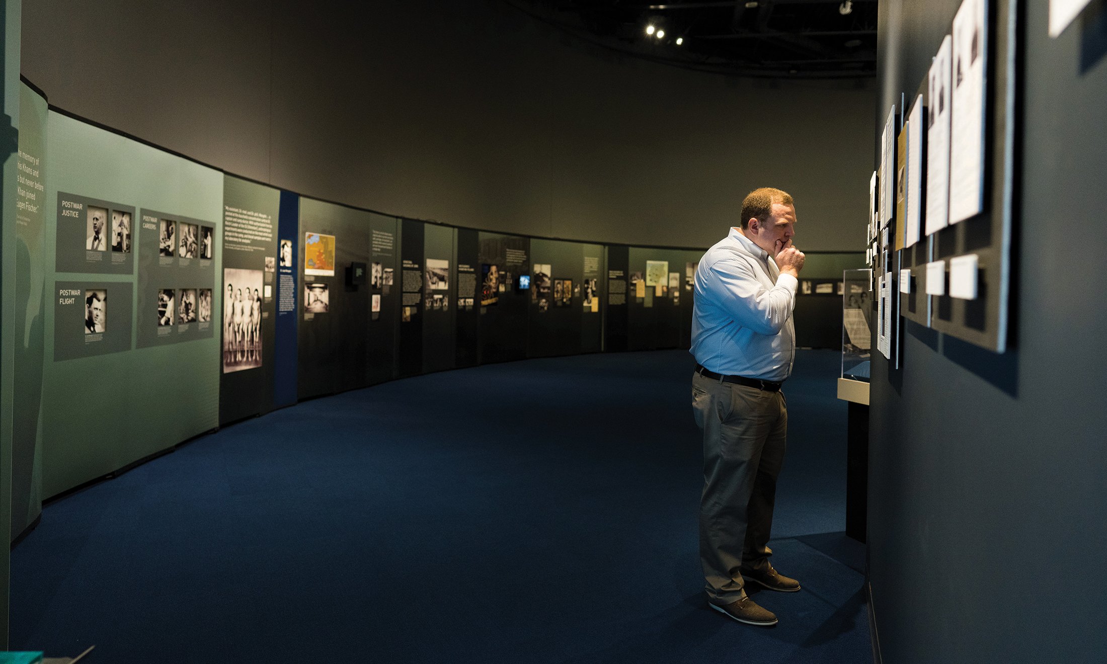 A man looking at a Holocaust exhibit