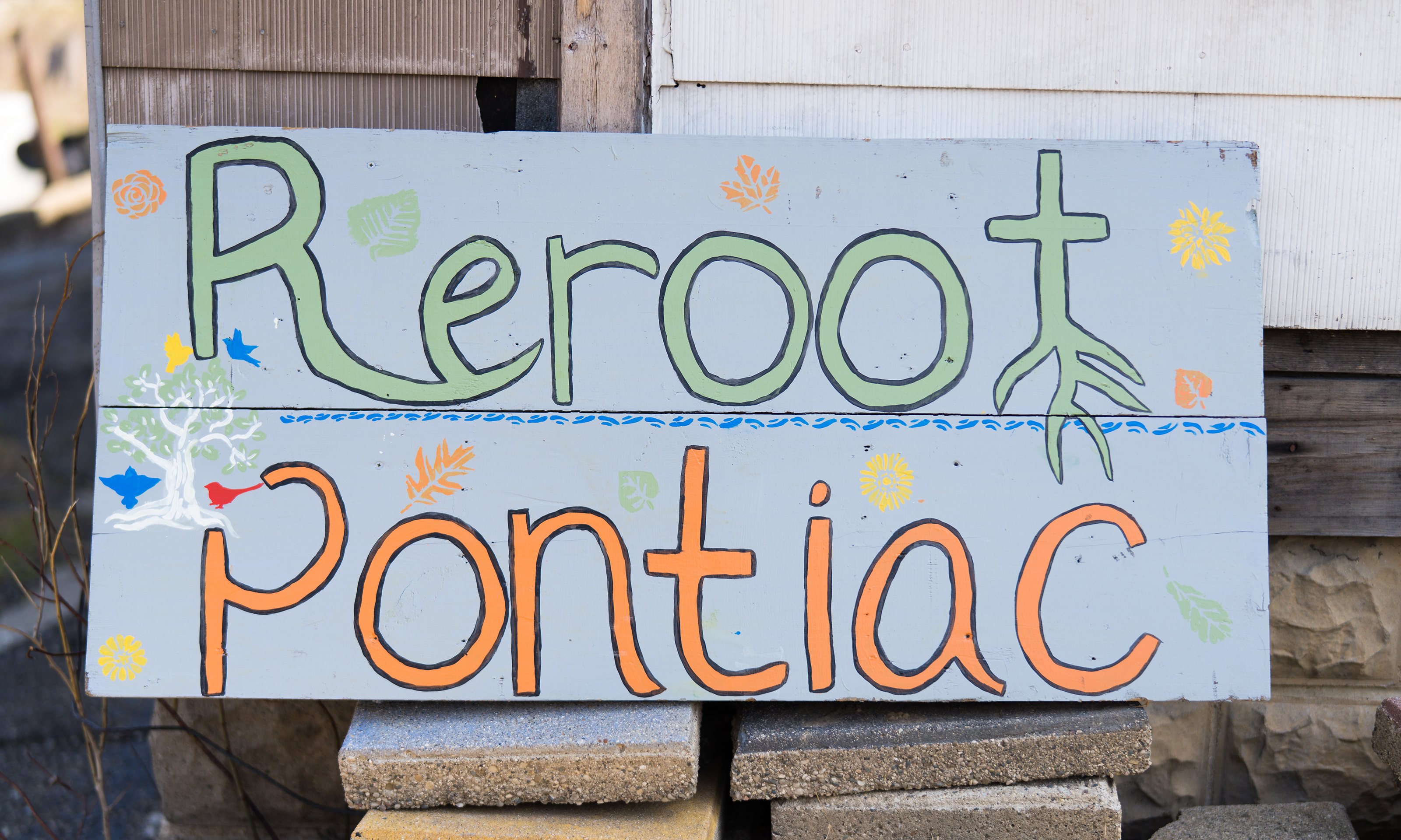 A sign that reads "Reroot Pontiac"