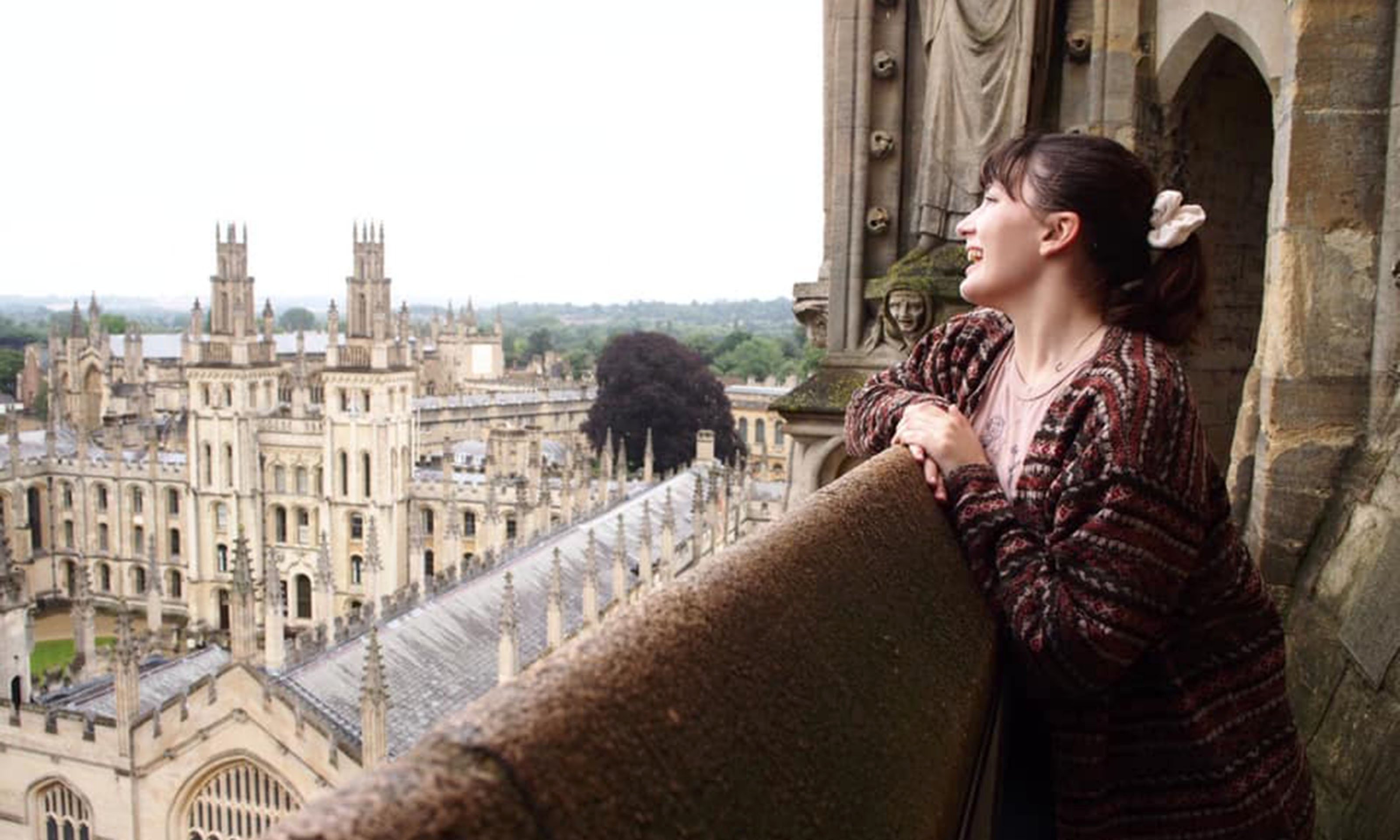 female student looking out over town in Great Britain