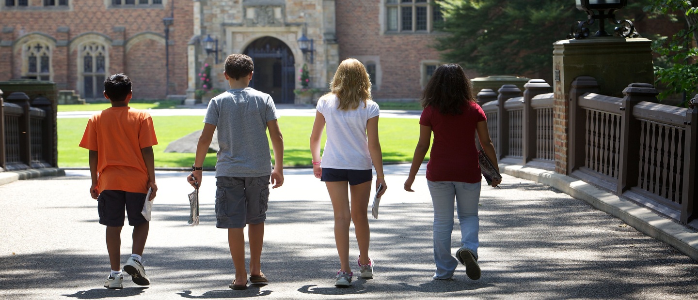 Four students walking outside of Meadow Brook Hall