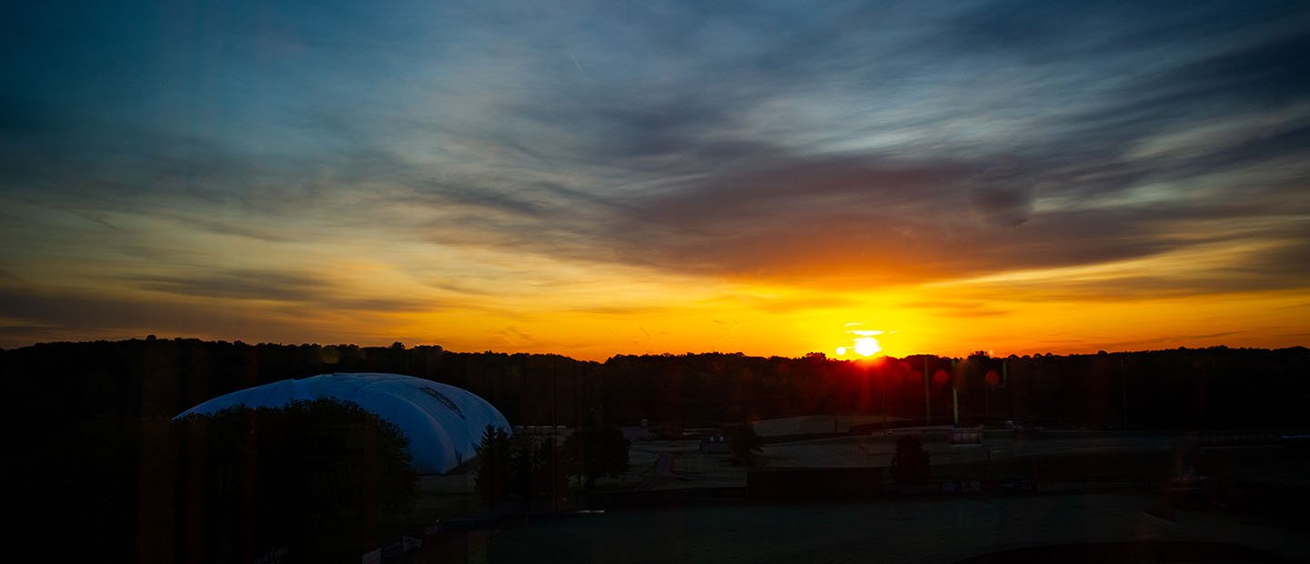 sun setting over Oakland University campus