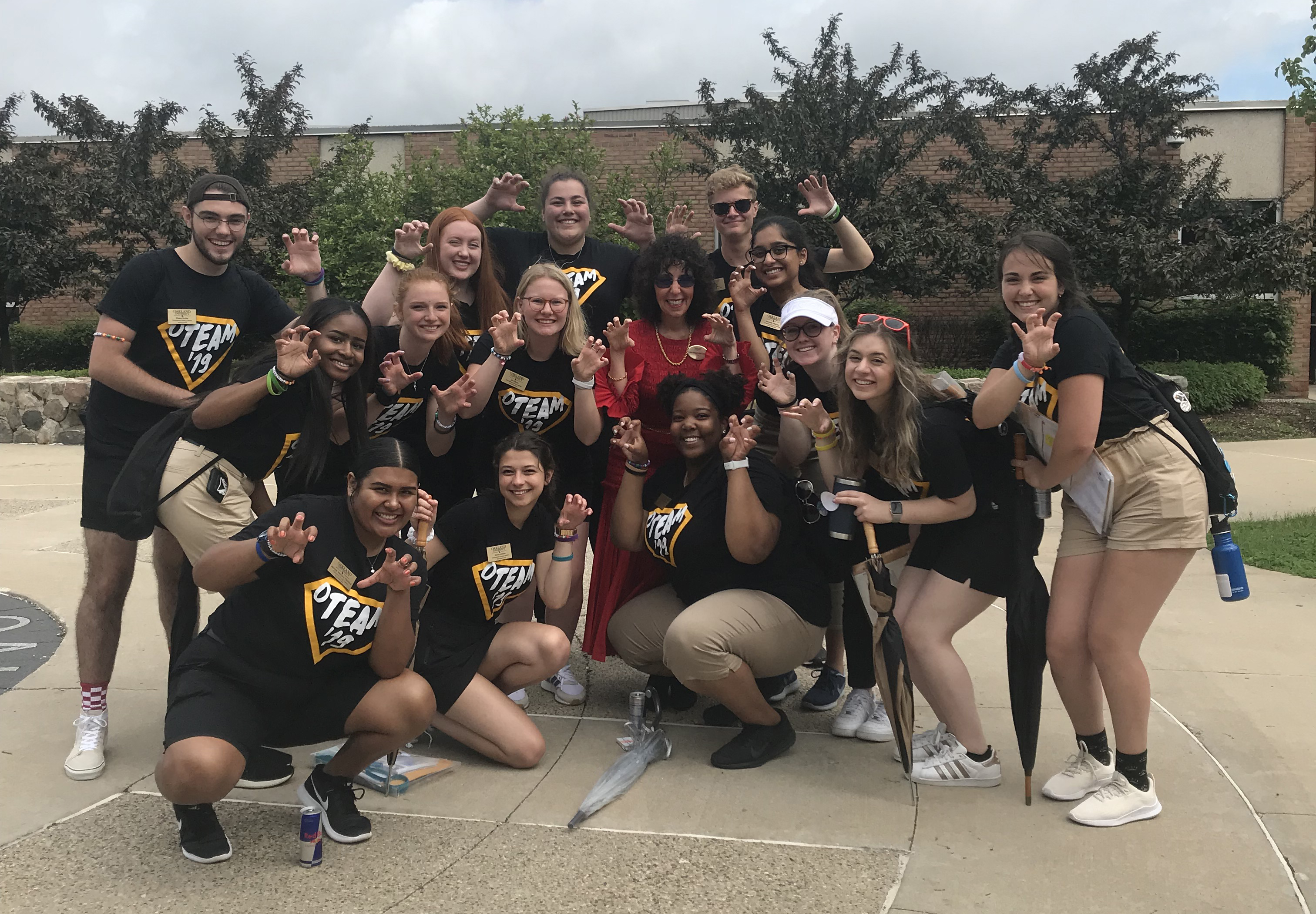 Group of people around president of OU smiling and posing in front of camera