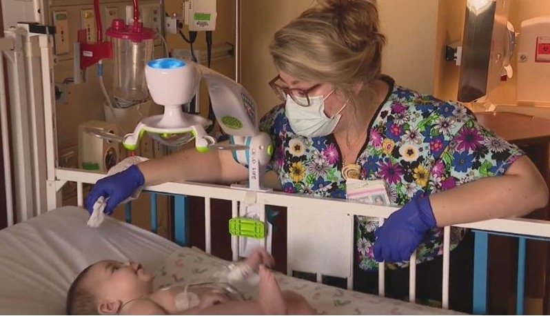 A nurse caring for a baby in a hospital