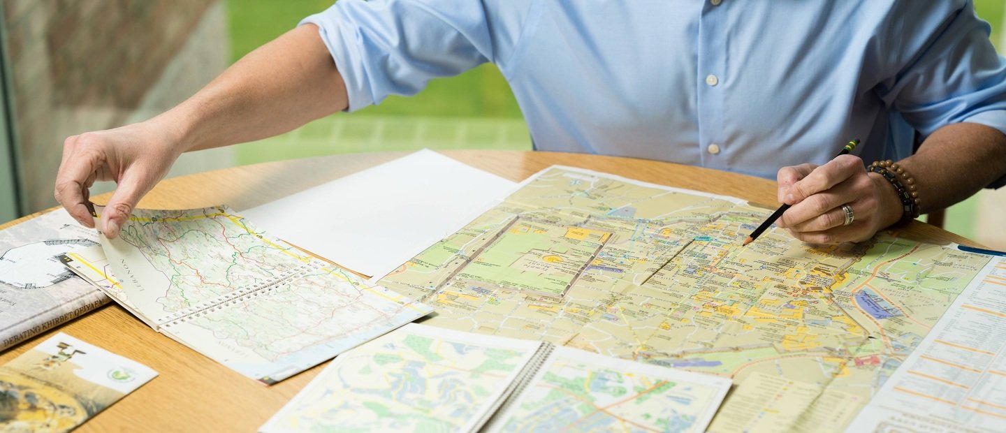 A person looking at maps