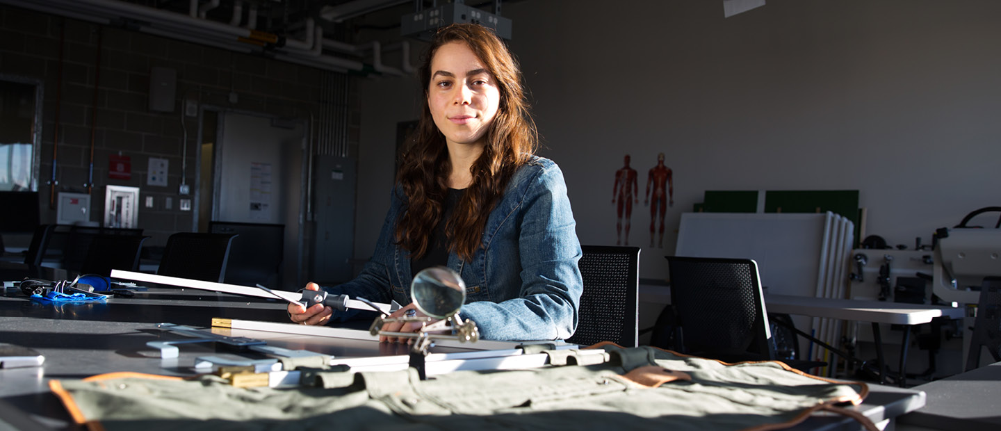Industrial and Systems Engineering woman working on equipment in a lab