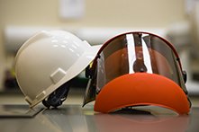 A white helmet and an orange face shield.