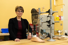 image of a woman standing in an orthotist and prosthetist lab.