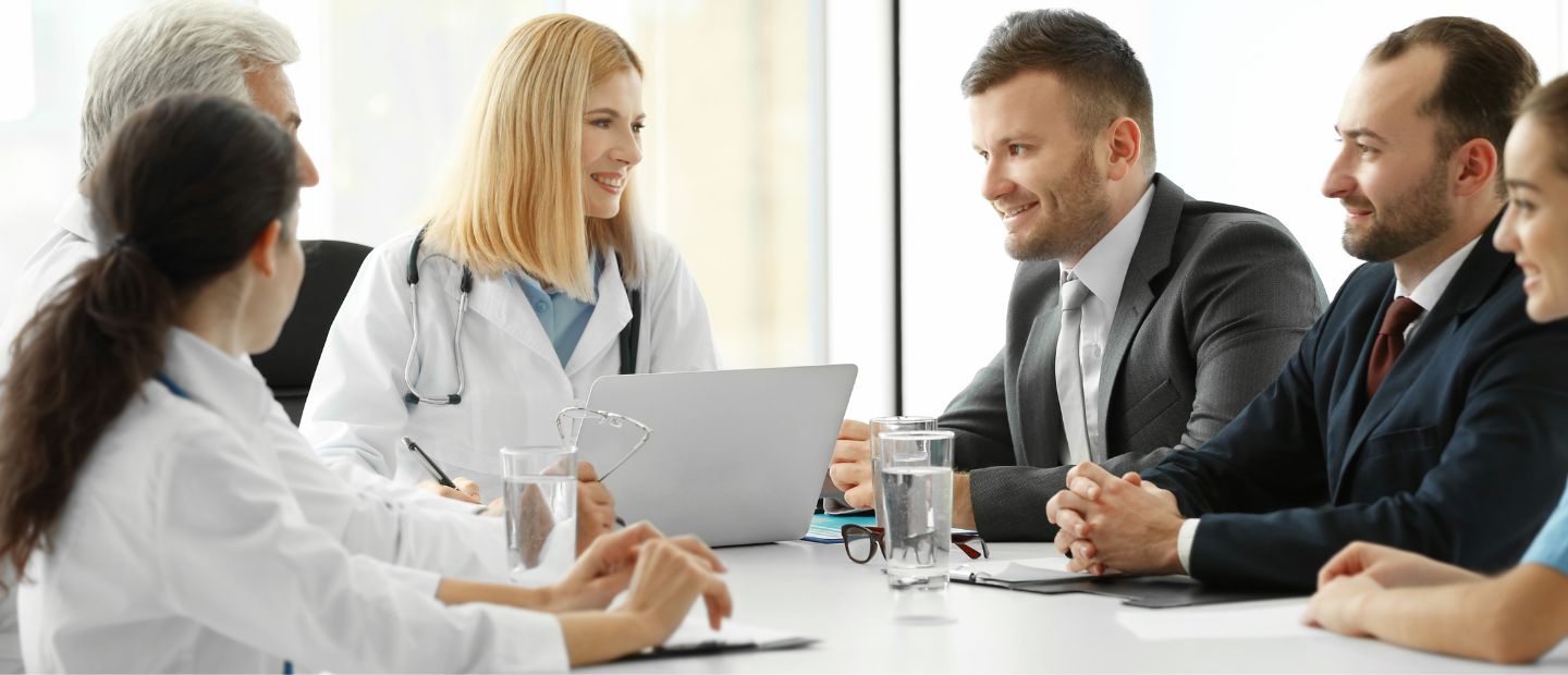 Interdisciplinary Healthcare Systems Healthcare professionals seated in a meeting room.
