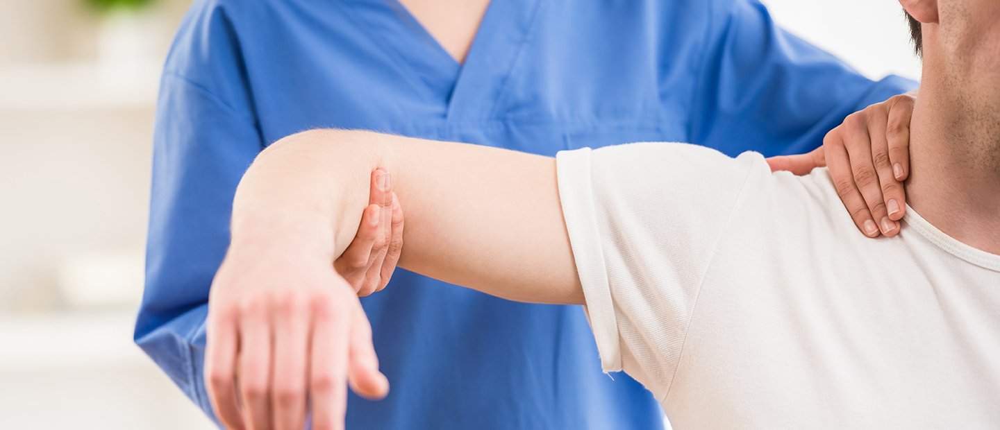 SHS-17081_SubpageBanners-15.jpg Physical therapist elevating a man's arm to shoulder height