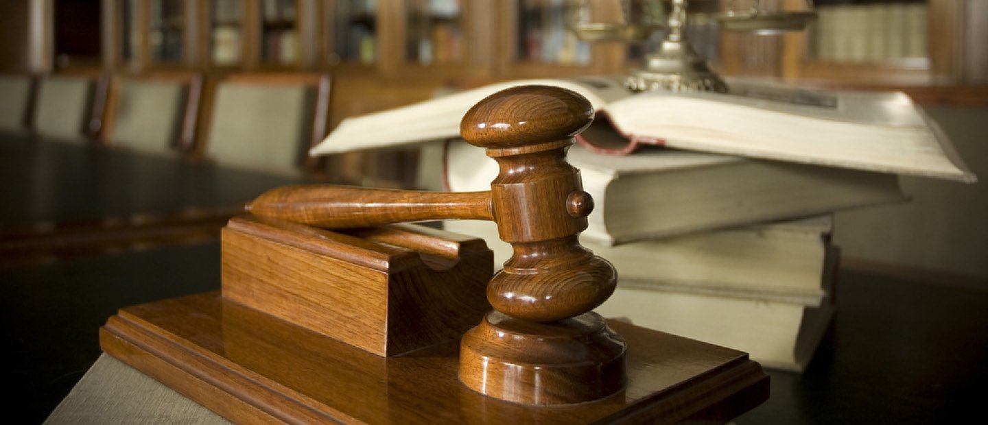 Criminal Justice A judge's gavel resting on a wooden stand.