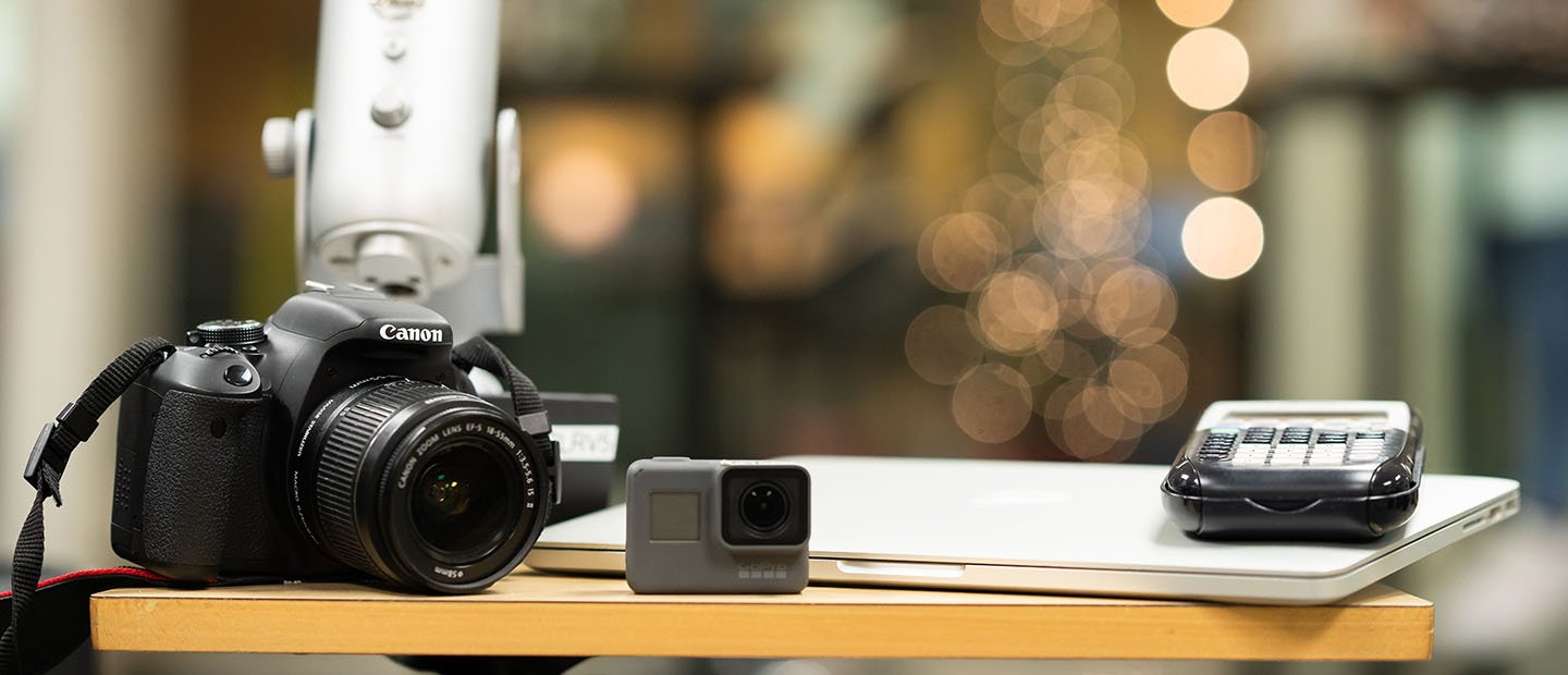 Canon camera and other electronic equipment on a table 