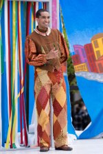 MTD student, Jalen, wearing a costume on a brightly decorated stage in a play.