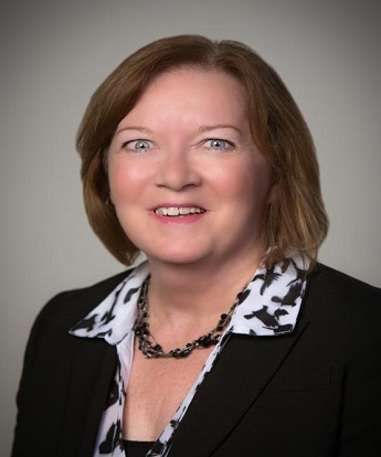 headshot of Debra Wenner in a suit and tie