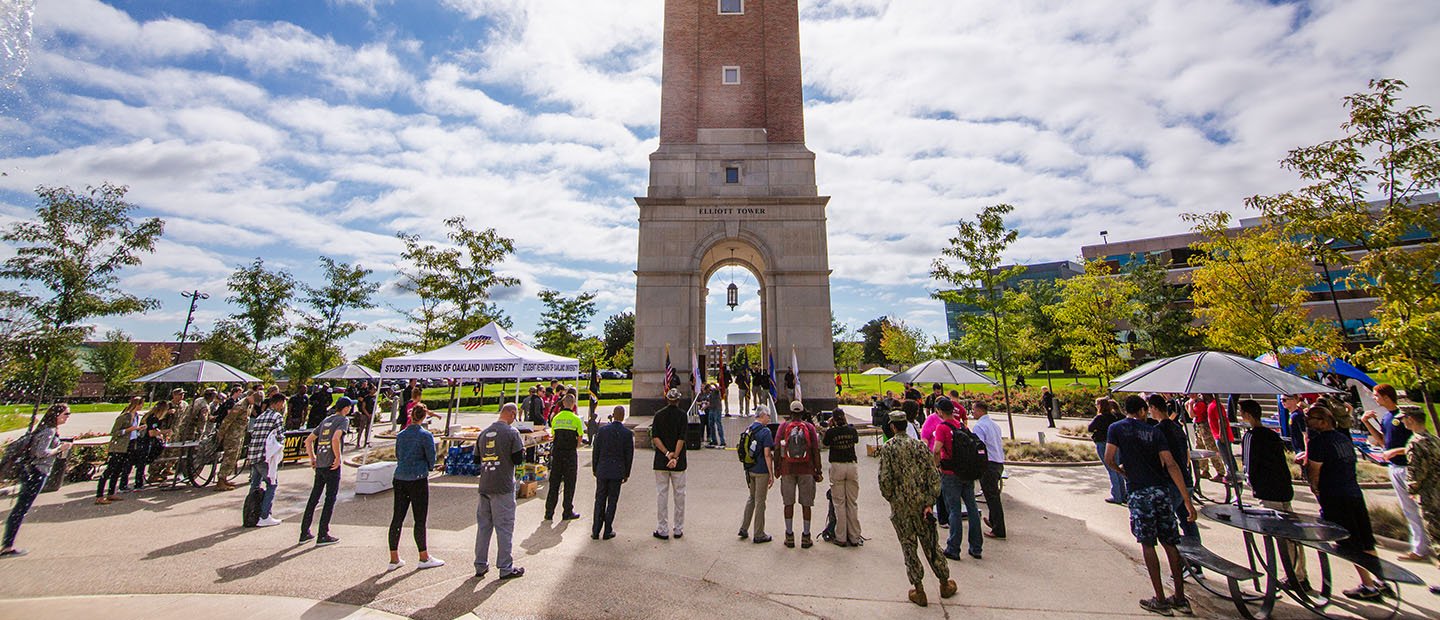 group of people standing in front of a clock tower