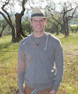 Photo of Rob Sidelinger standing outdoors in front of trees