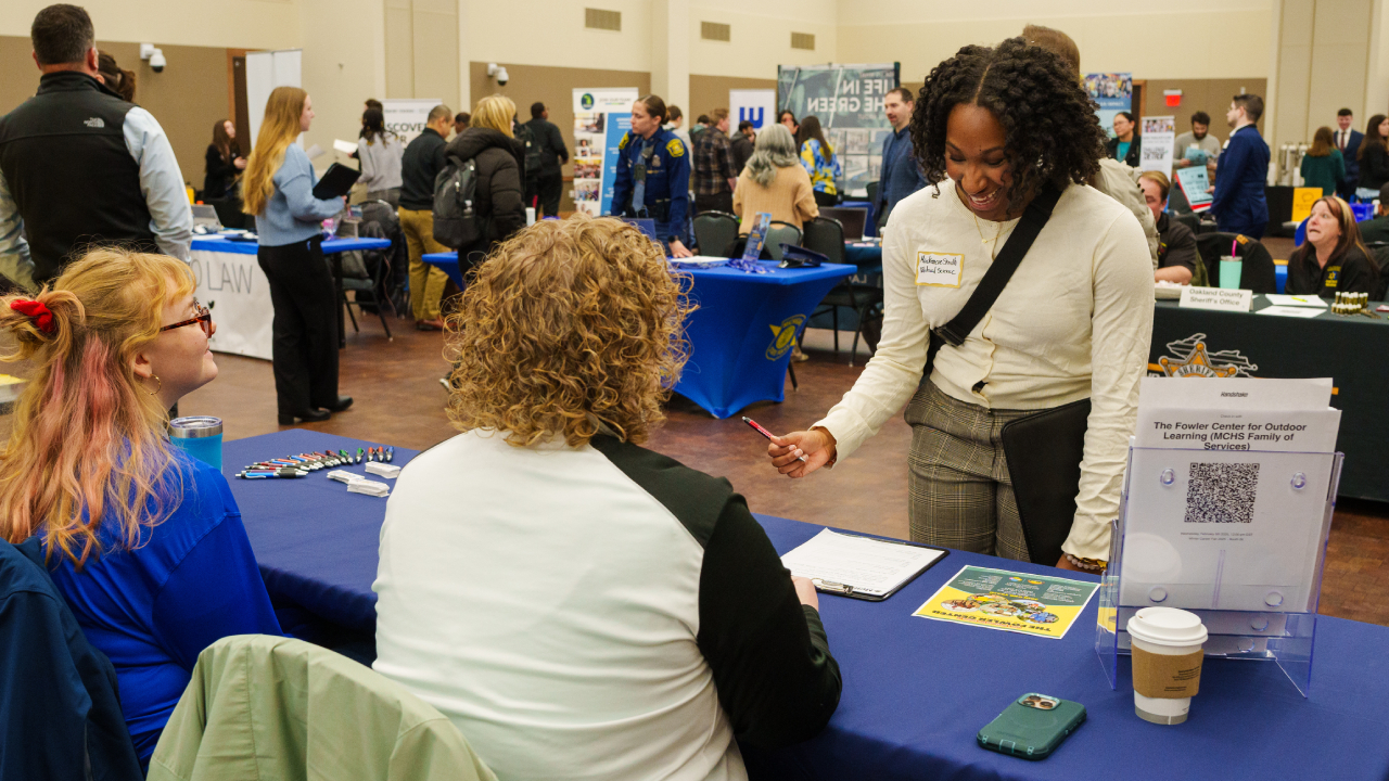 student interacting with employer representative