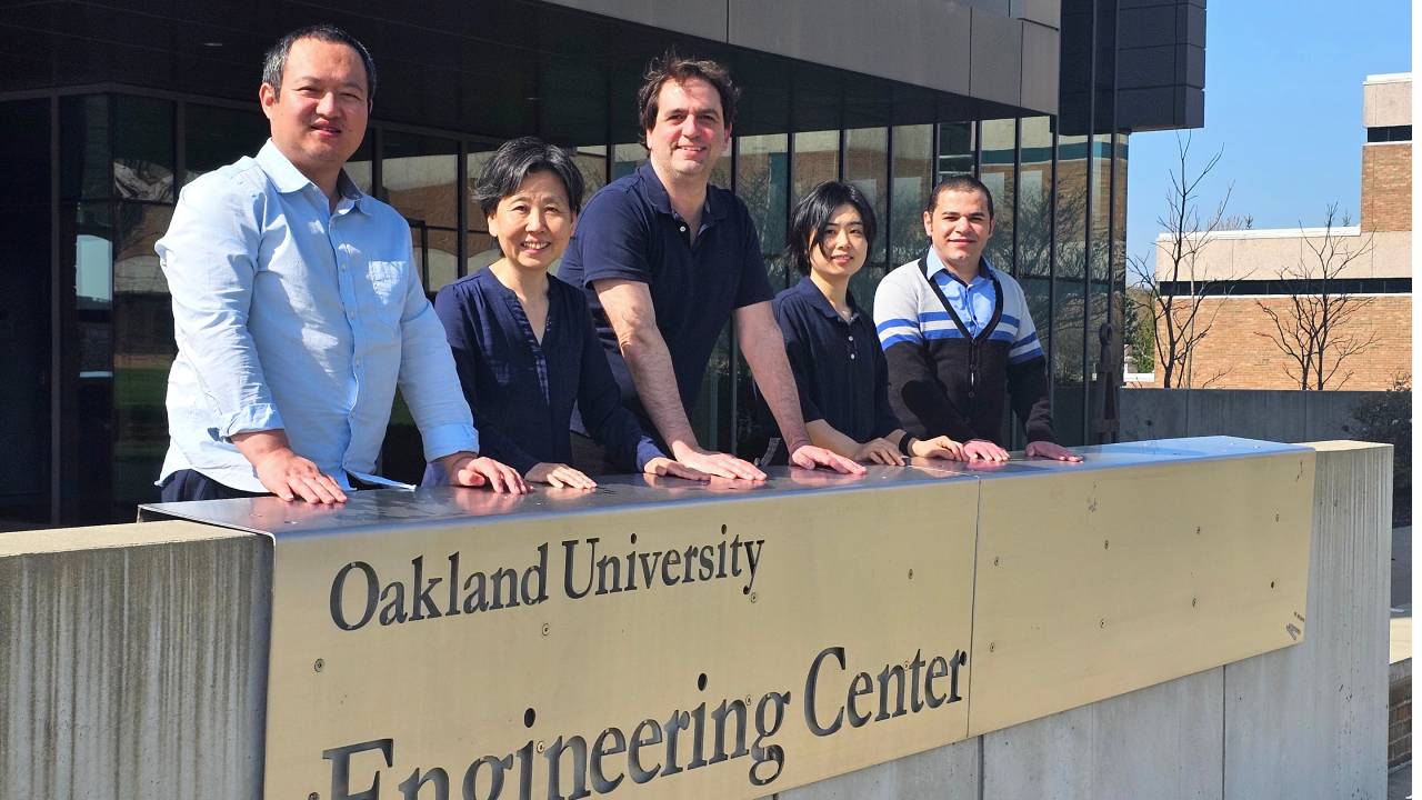 OU faculty members in front of Engineering Center