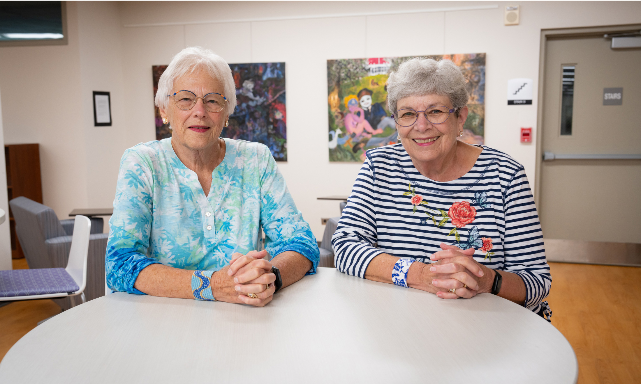 Two women sitting inside