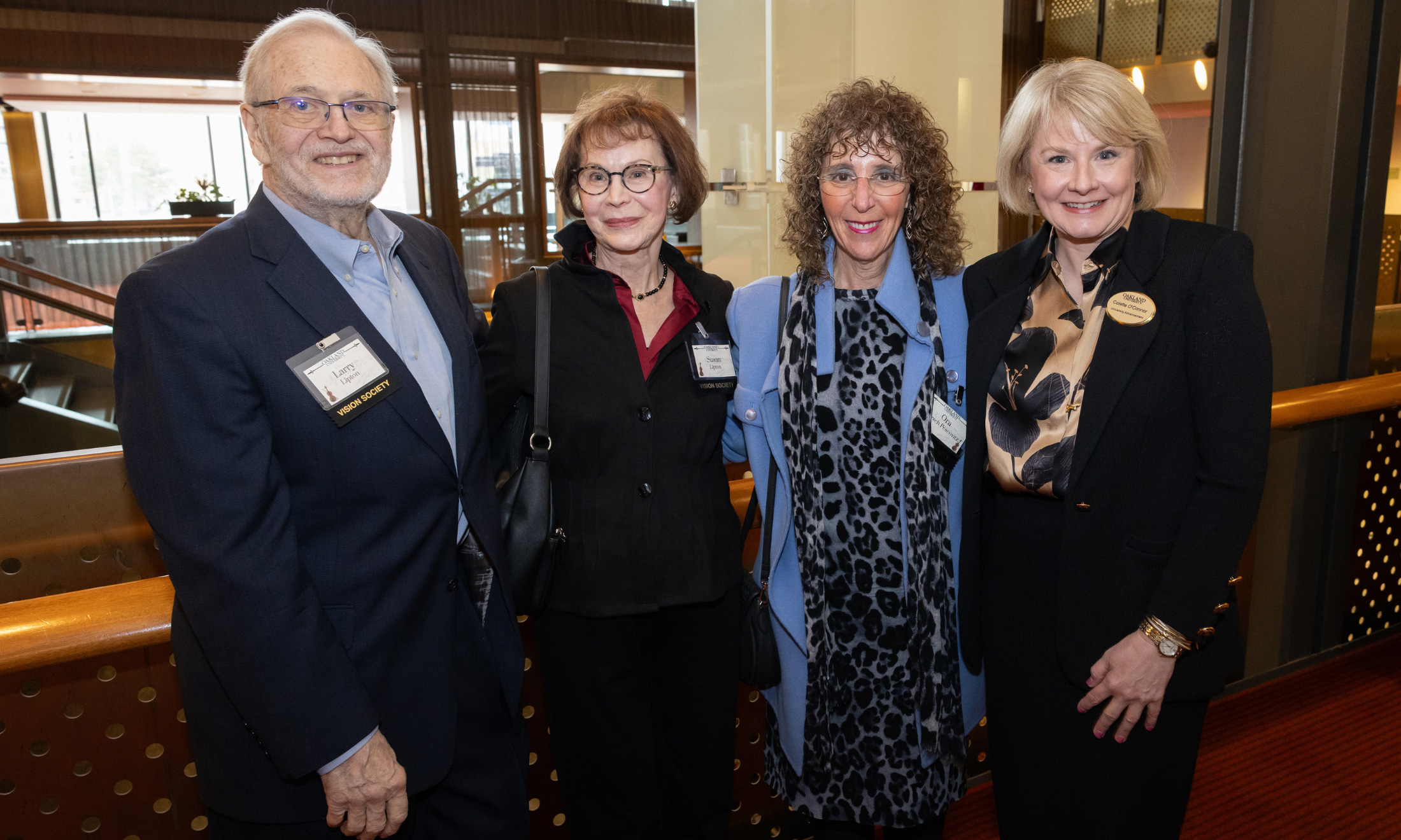 Four adults standing inside