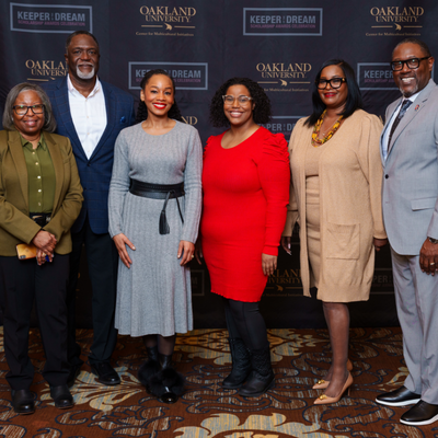 Adults in formal attire posing for a group photo