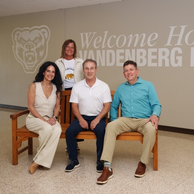 Four adults posing for a group photo