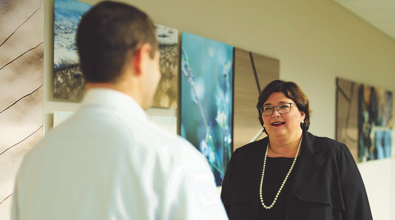 A woman talking to someone in a hallway