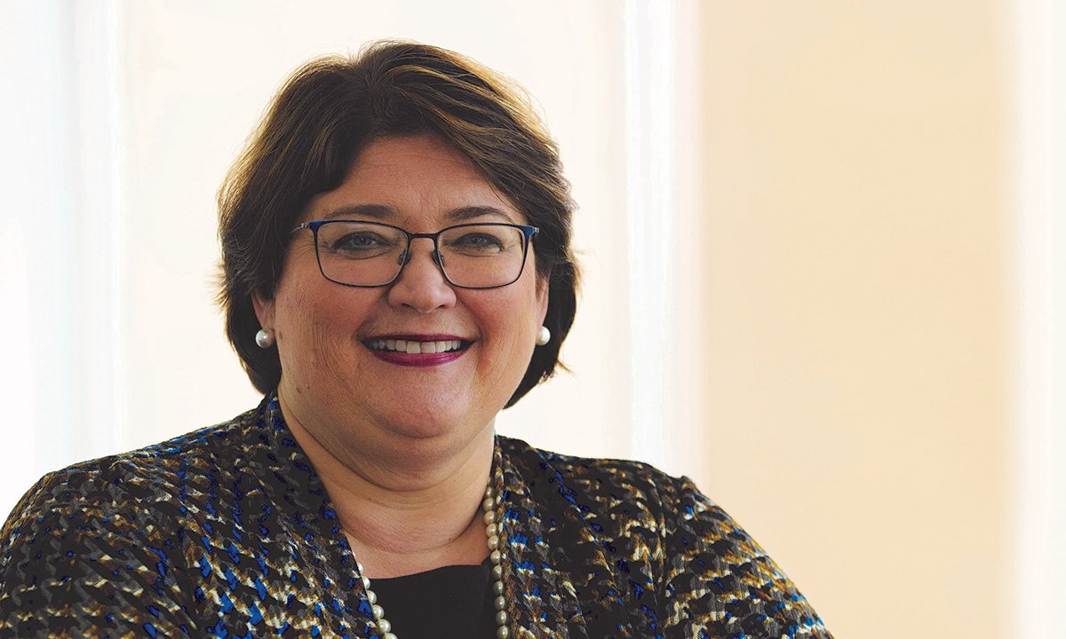 Woman smiles towards camera.