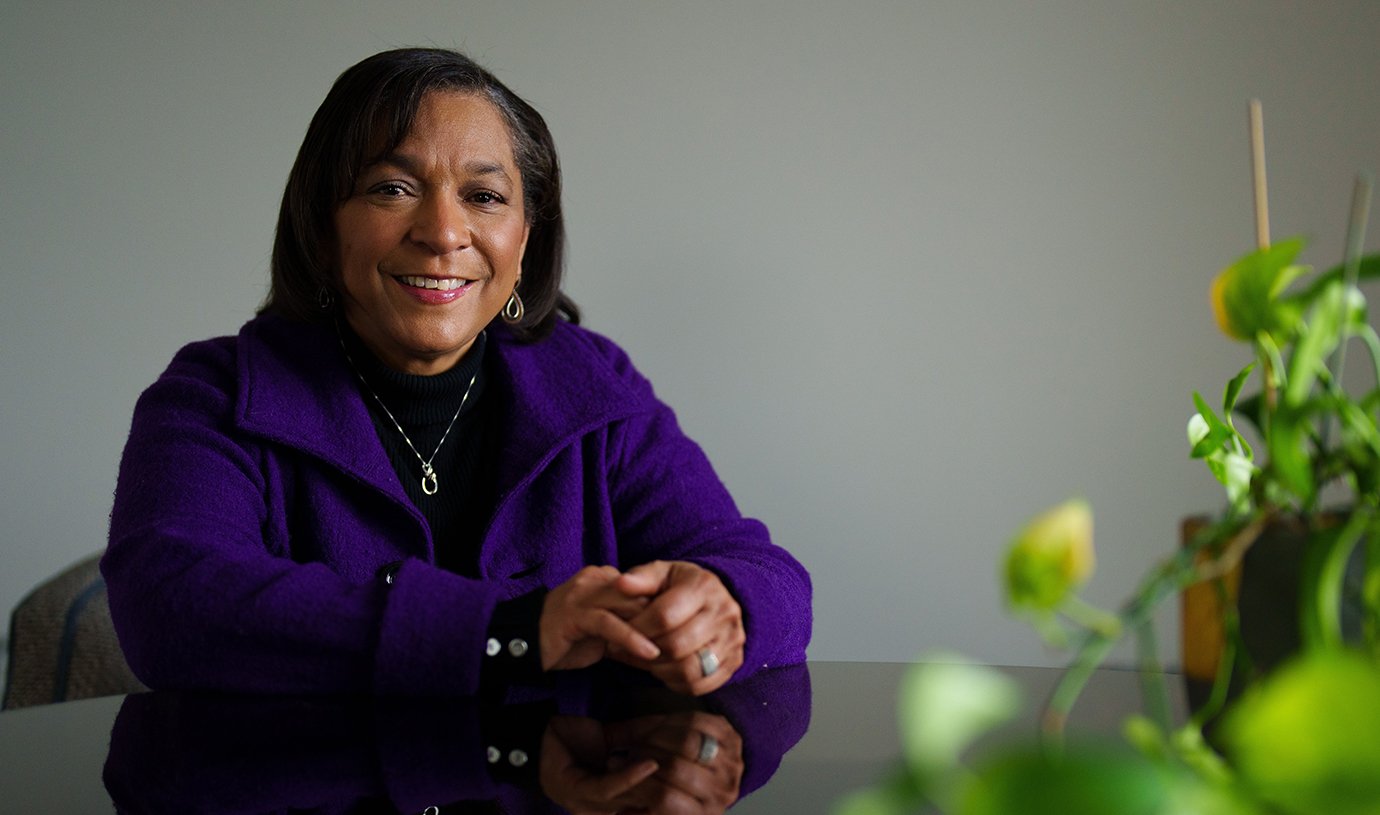 A woman sitting and smiling