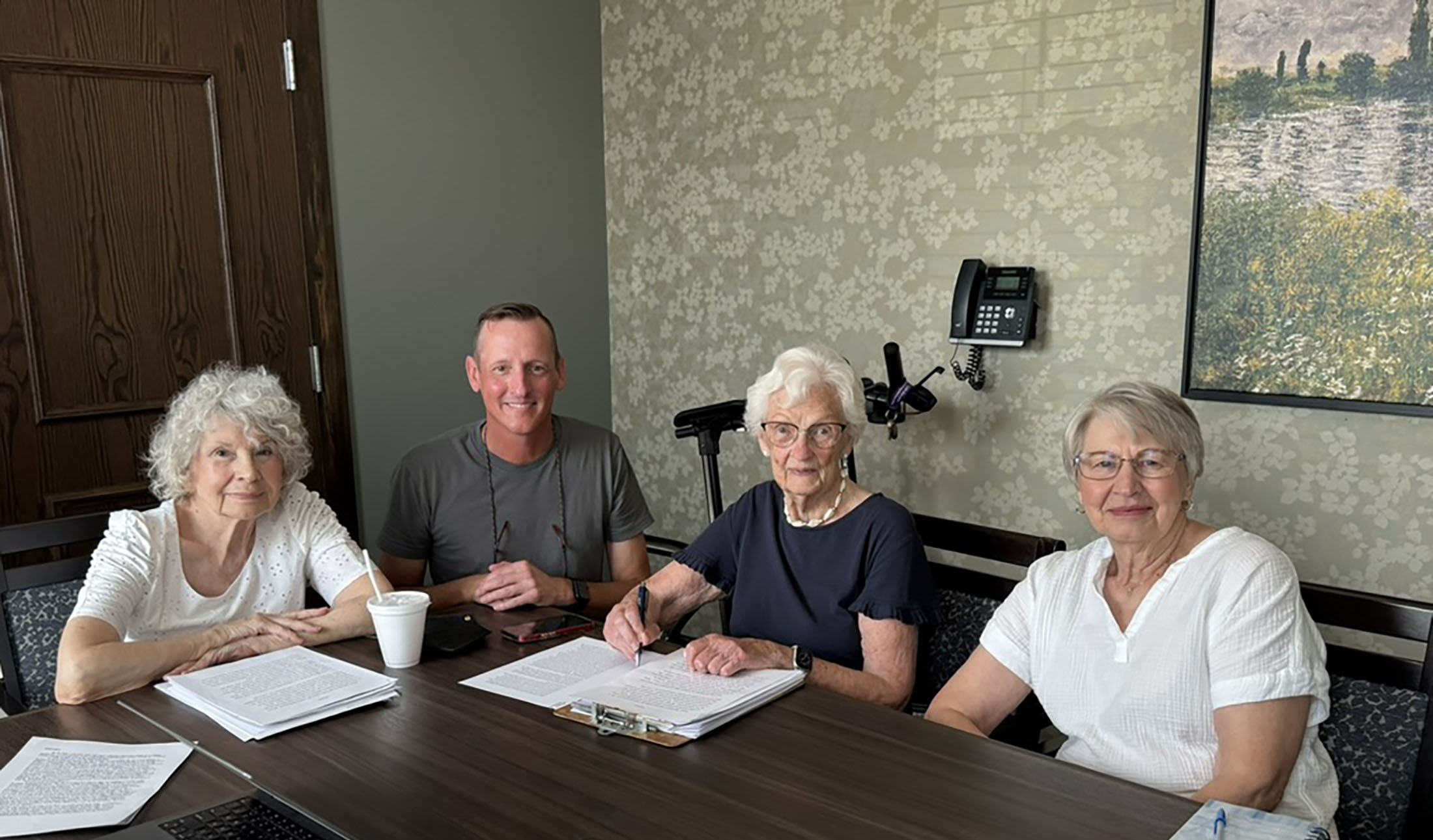 Professor of Writing and Rhetoric Greg Giberson poses for a photo with the three women who took his writing workshop at Pomeroy.