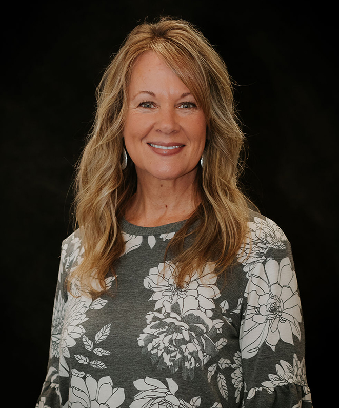Director of Field & Student Support for the Criminal Justice Program Kimberly Byrd poses for a photo in front of a black background.