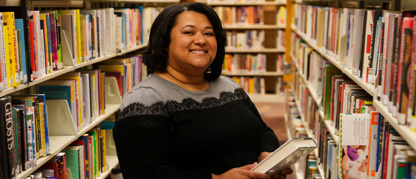 A woman posing for a photo in Kresge Library