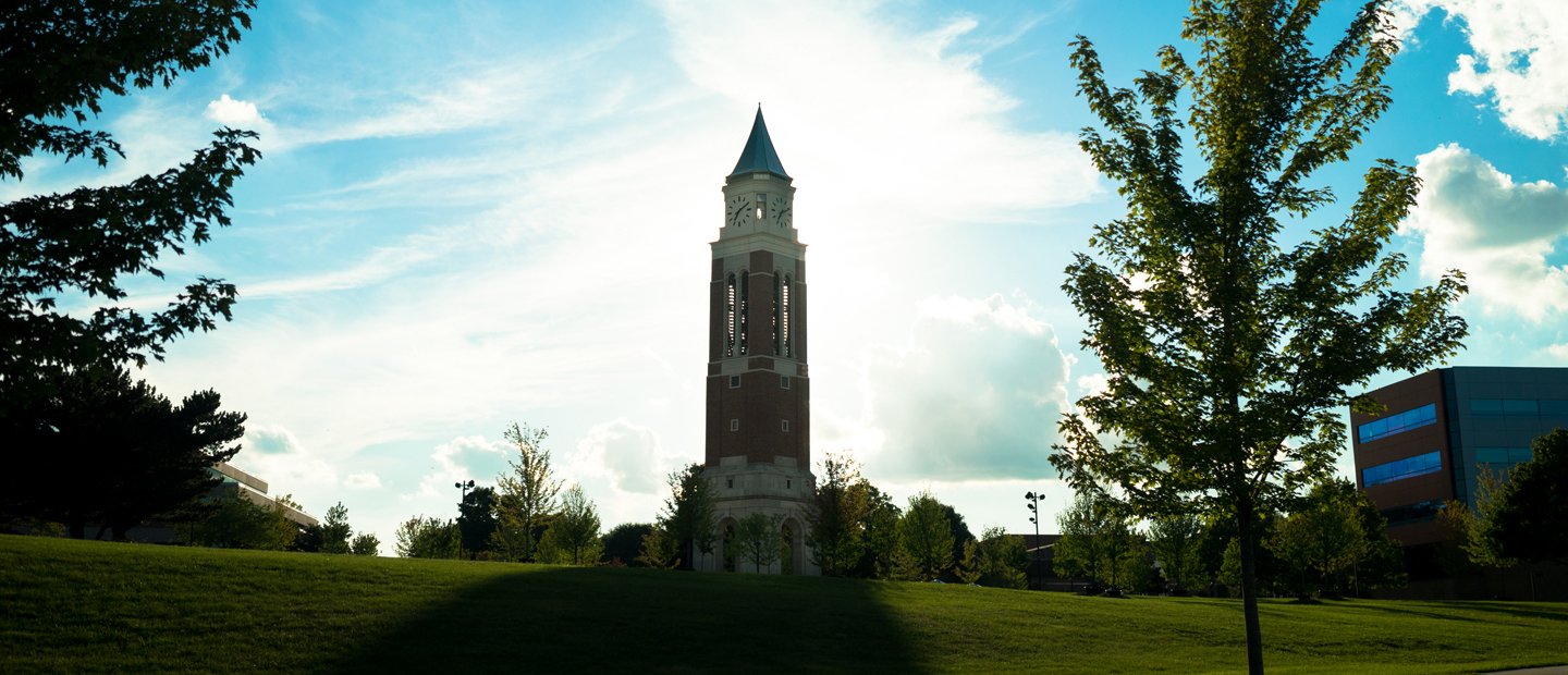 Elliott Tower with the sun shining behind it