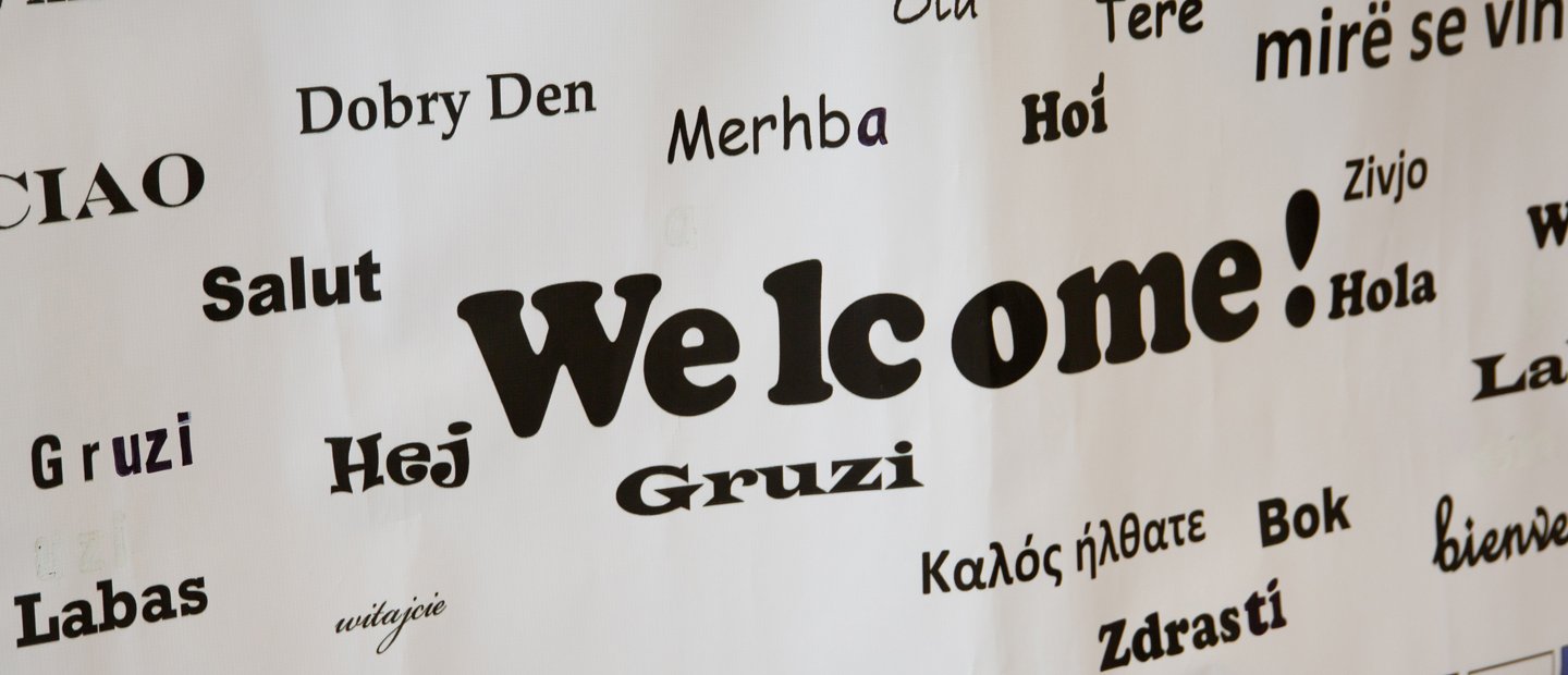 a sign that says Welcome! in English and many other languages