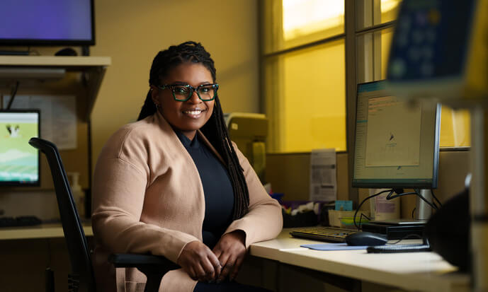 An image of Kala Seawright sitting at a desk