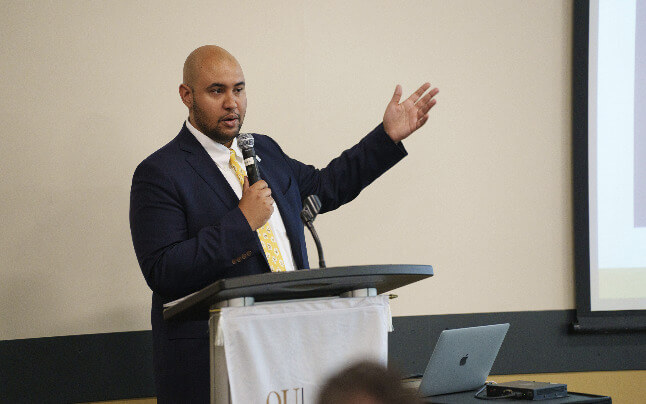 An image of Jordan Nash speaking at an event