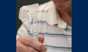 A person holds a vial