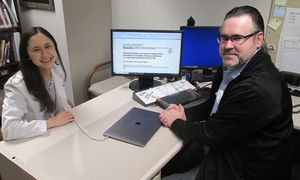A student and clinical faculty member sitting at a desk