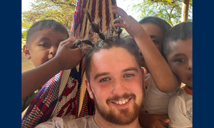 The student with younger people playing with his hair