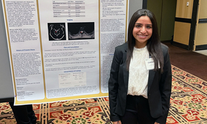 A student in front of a poster