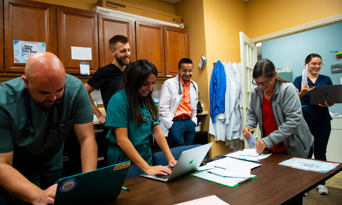 An image of OUWB medical students and doctors talking