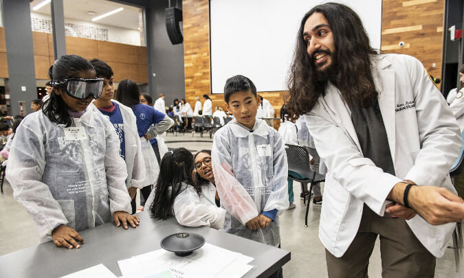 An image of an OUWB student teaching Reach Out to Youth participants