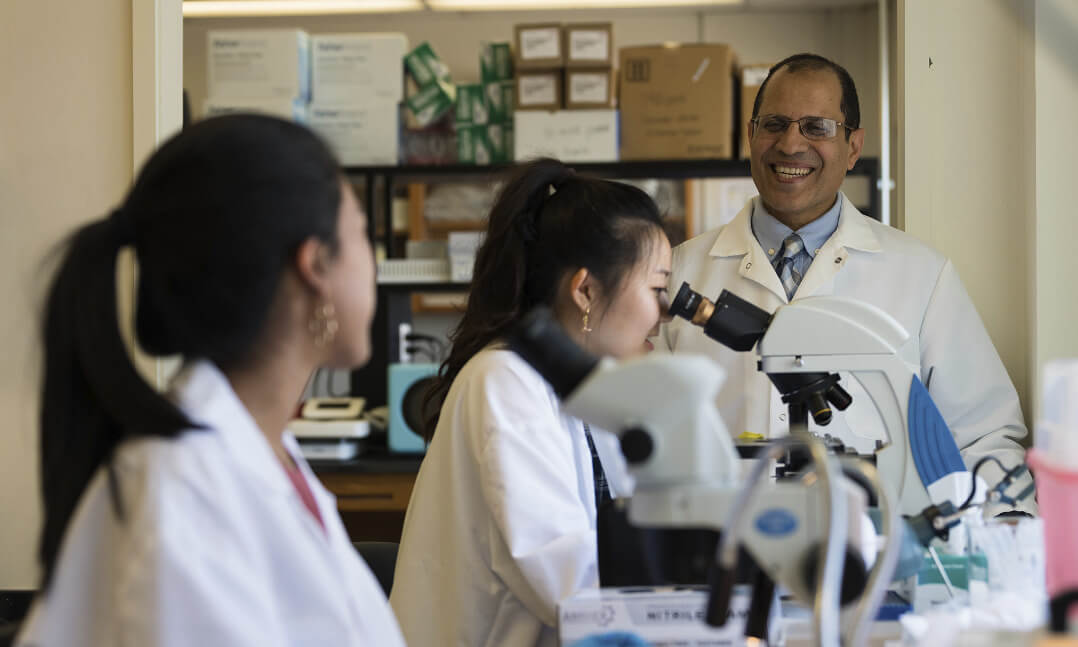 Student looking into microscope