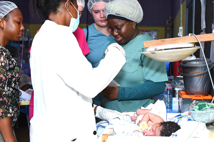 Students in Ghana observe a medical procedure