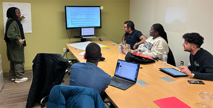 A group of students engage in discussion