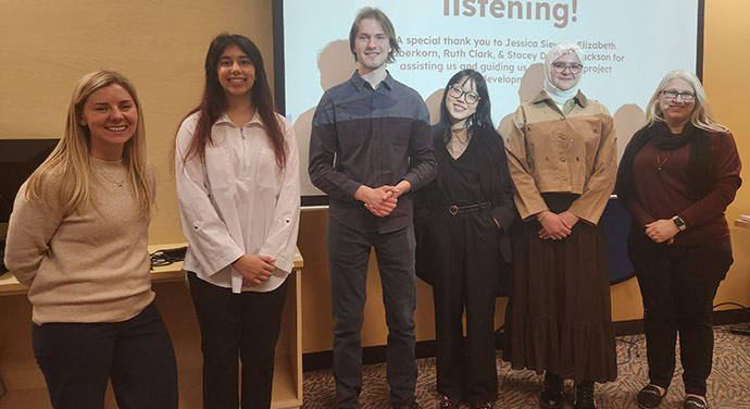 A group of students and professionals smile