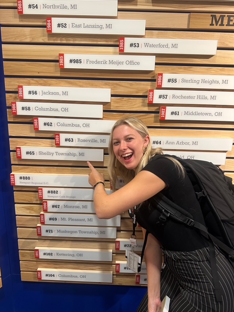 Student pointing to a sign