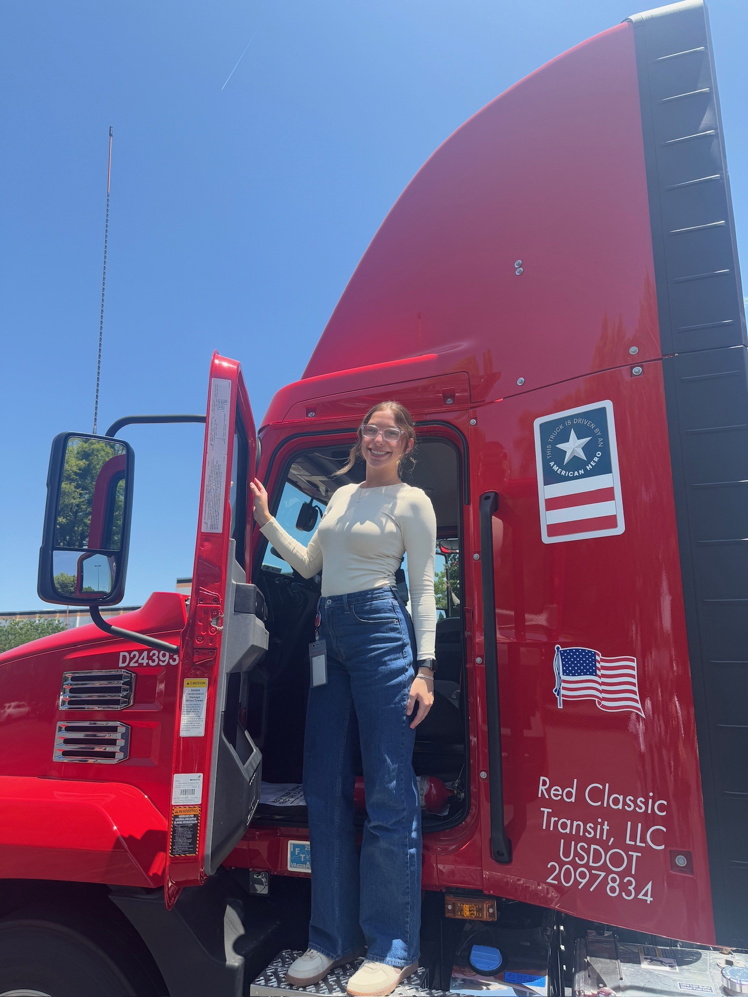 Student standing on the side of a truck