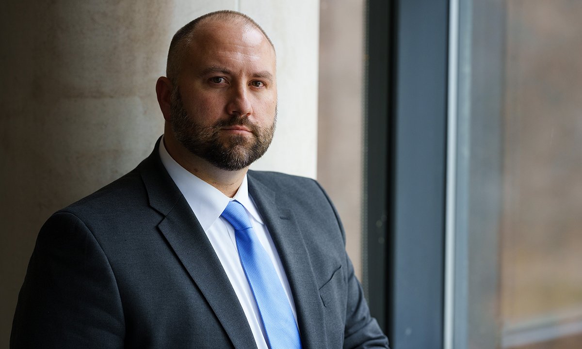 A man posing by a window.