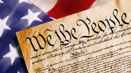 Constitution text with American flag backdrop