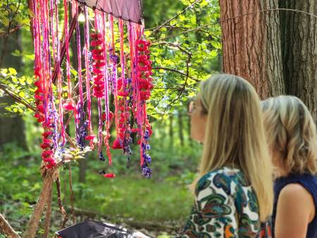 Two women looking at art outside Meadow Brook Hall
